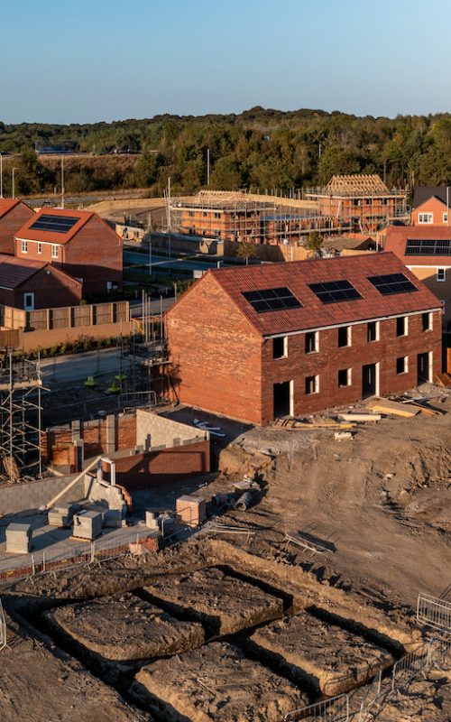 Aerial panoramic landscape view of a new build housing estate with houses under construction to fill the gap in the UK home shortage and supplement the UK Government's Right To Buy policy